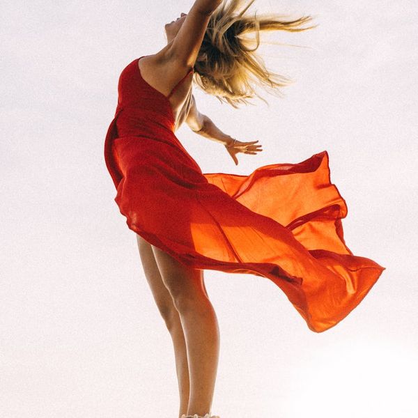 Woman feeling energetic and balanced in a bright, open space.